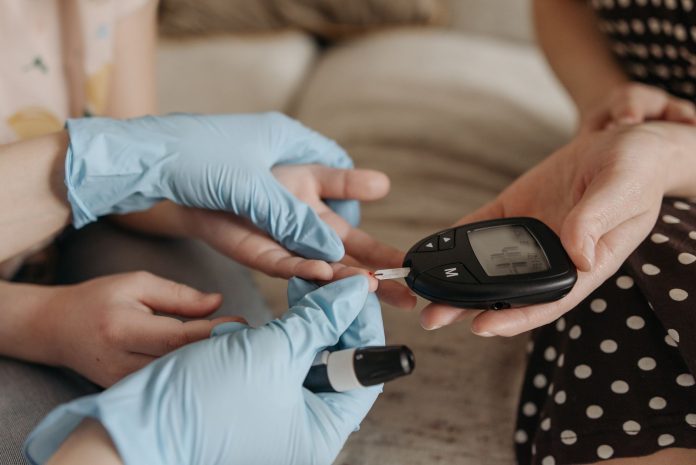pexels-photo-7653134 close up of hands holding glucose meter